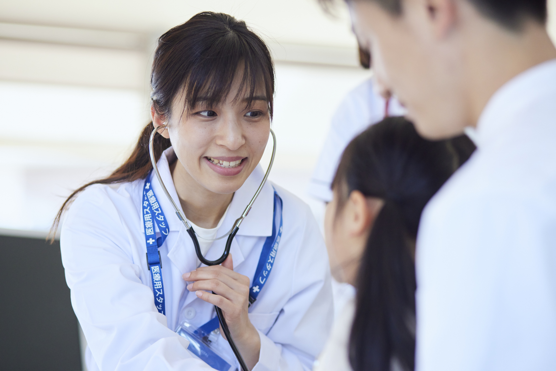 doctor examining a child patient in a hospital examination room